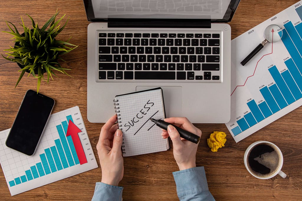 Workspace with charts and a laptop, planning a successful ecommerce growth strategy.