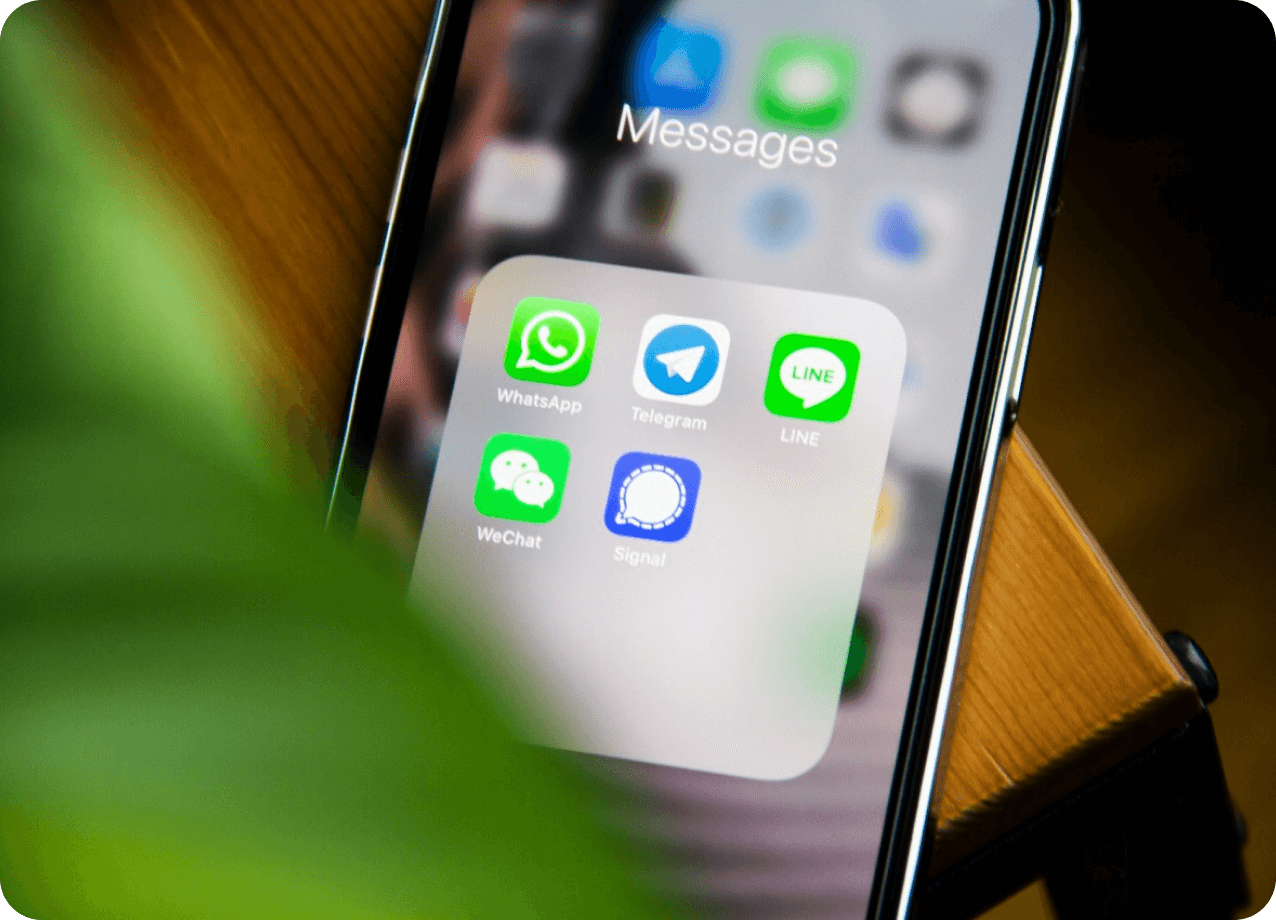 Messaging app icons displayed on a phone, including WhatsApp, Telegram, LINE, WeChat, and Signal