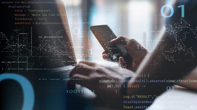 Digital security and coding displayed on a laptop and mobile phone with futuristic data overlays