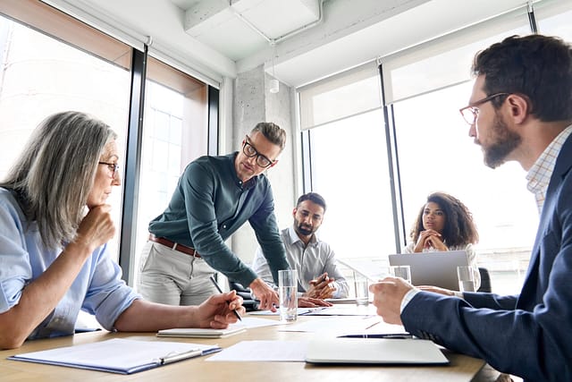 Team discussion during a strategy meeting in a modern office setting